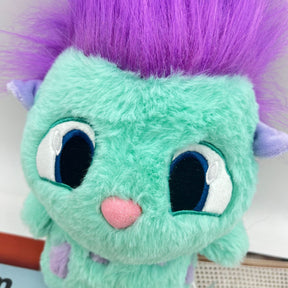 Personagem Bibble com corpo azul turquesa, topete roxo e pequenas asas nas costas