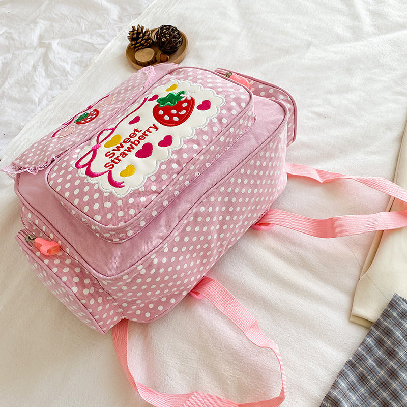 Mochila rosa e branca com estampas em exibição frontal